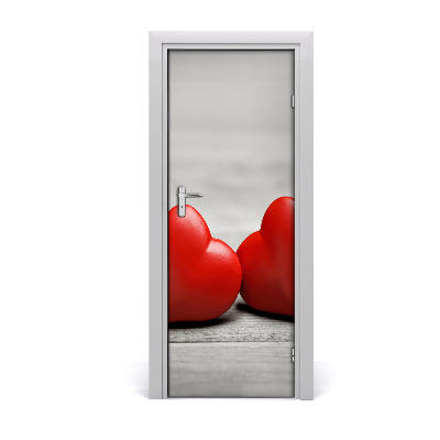 Ajtóposzter öntapadós Piros szívek egy fából készült háttér