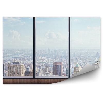 Fotótapéta Kilátás fentről a városra az ablakon kívül