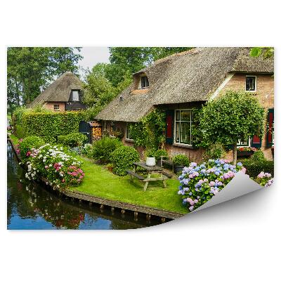 Fotótapéta vidéki házak fák virágok folyó ég felhők pad