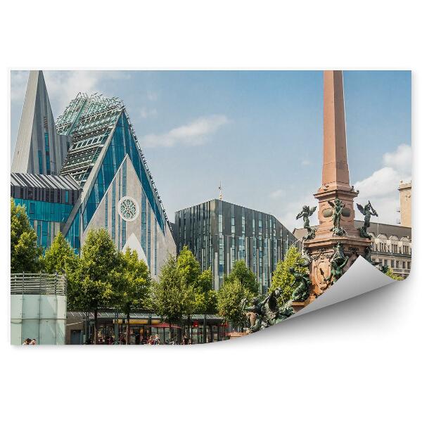 Öntapadó fotótapéta Panorama city Lipcsei épületek szökőkút fák virágok kerékpáros égbolt felhők