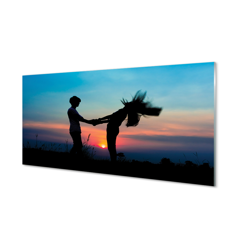 Emberek naplemente ég a réten Üvegkép