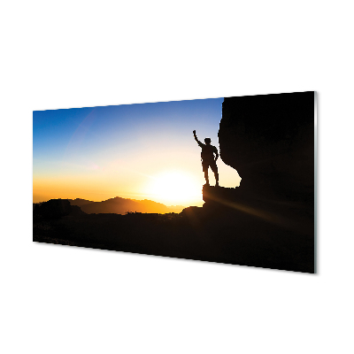 Ember egy sziklán napkeltekor Üvegkép falra
